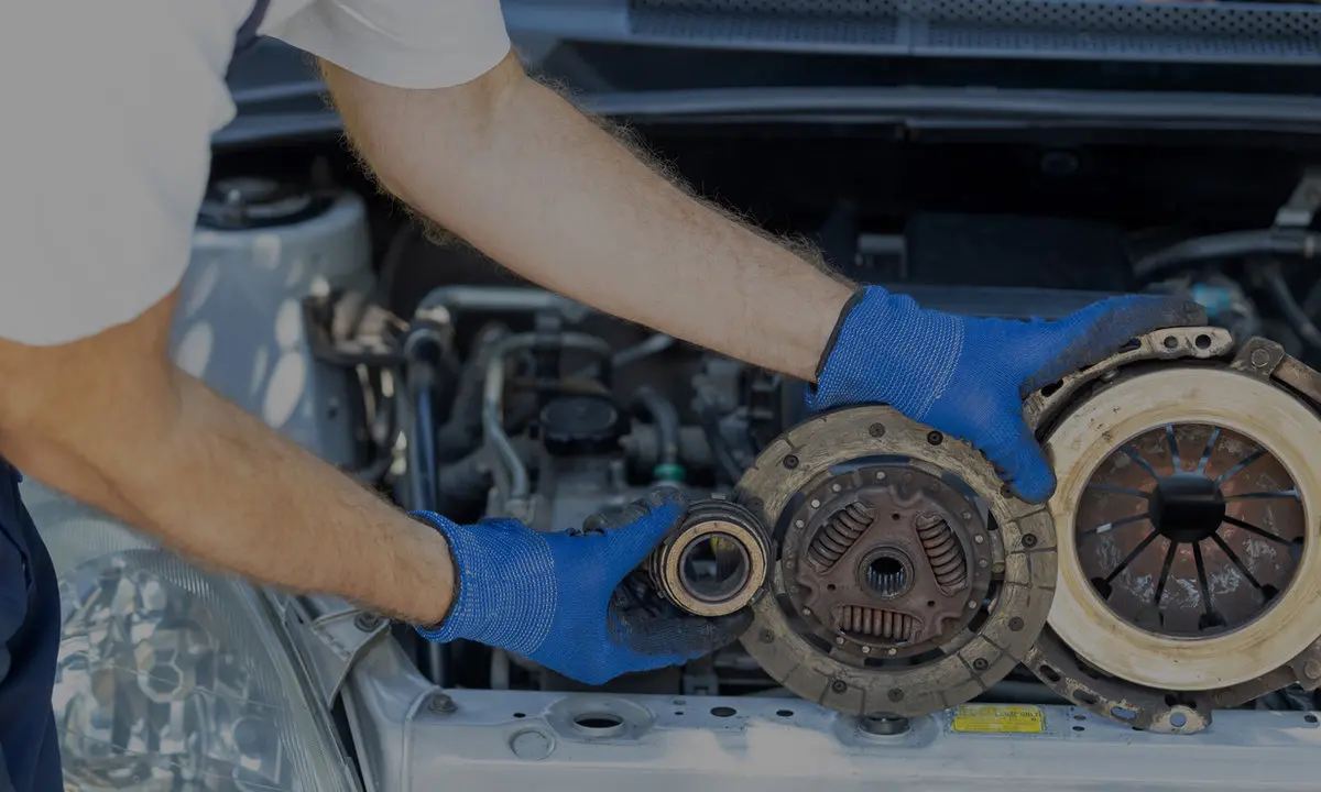Technician replacing a vehicle clutch during a mechanical repair